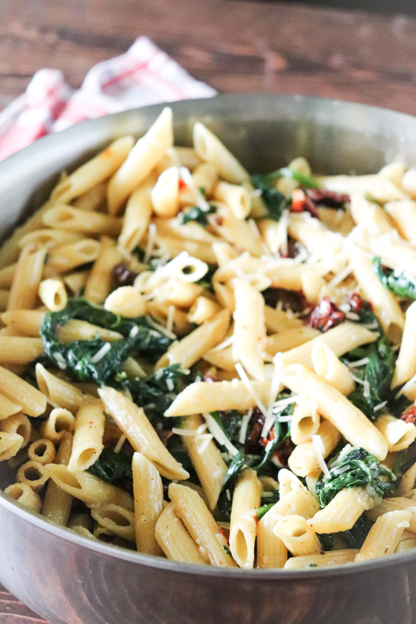 skillet of protein pasta with spinach, parmesan and sun-dried tomatoes