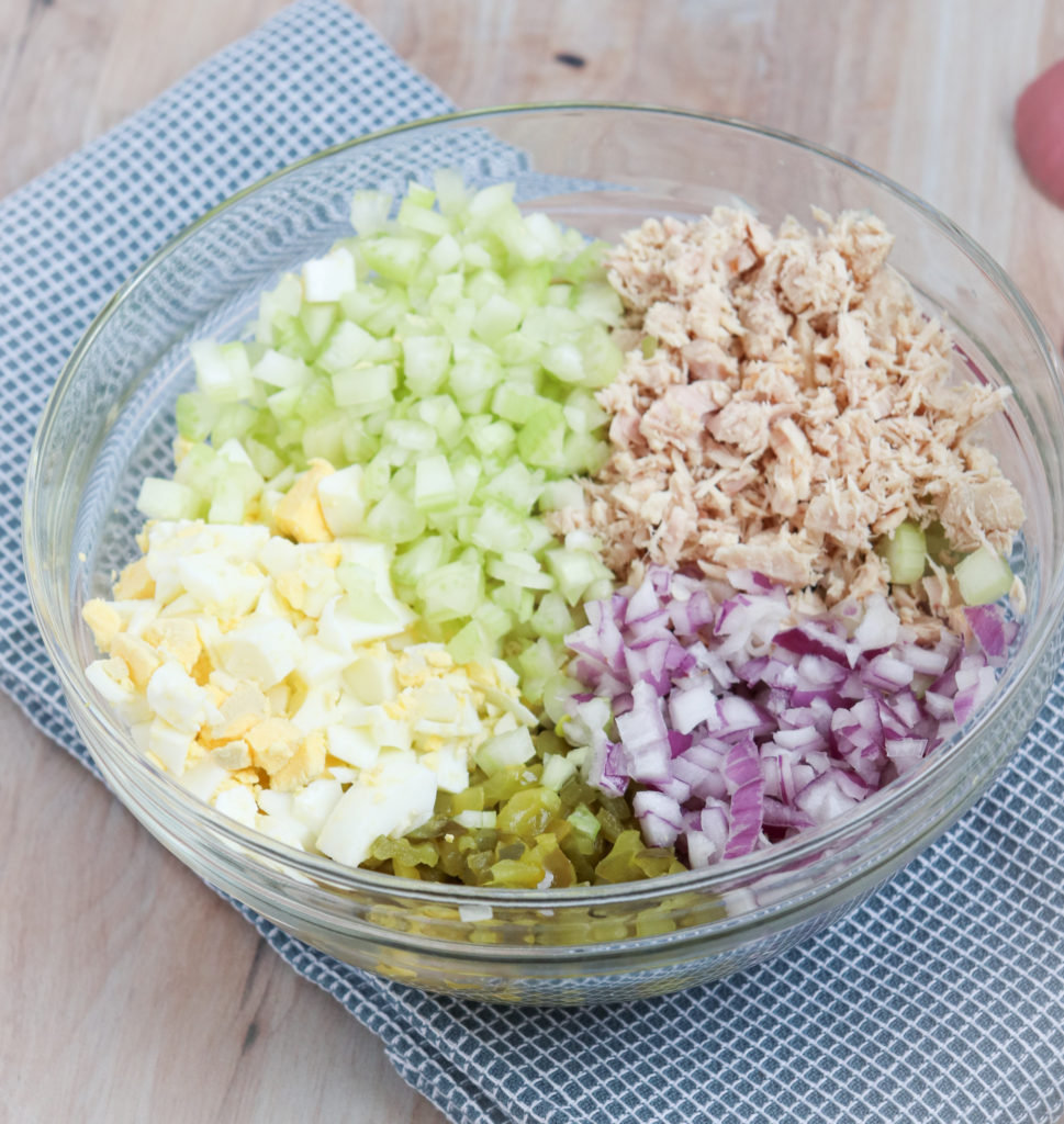 bowl of diced celery, pickles, purple onion, eggs and flaked tuna