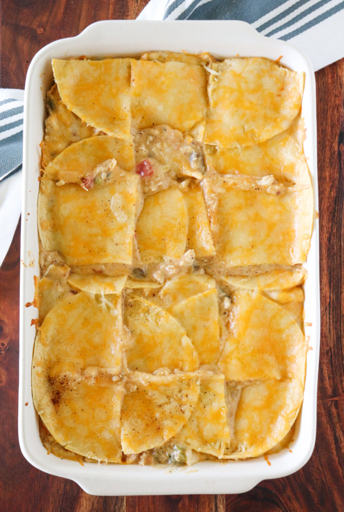 casserole dish of king ranch chicken cut into square pieces