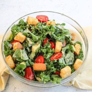 bowl of prepared kale caesar tomato salad