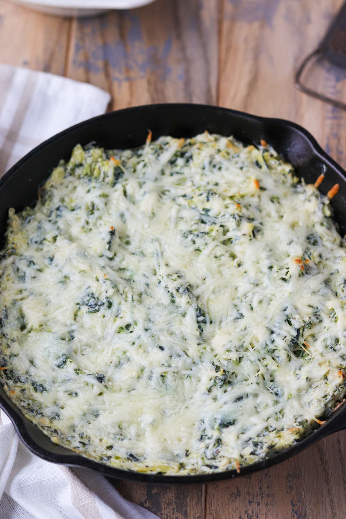 cast iron skilled of bake spinach artichoke dip with mozzarella cheese