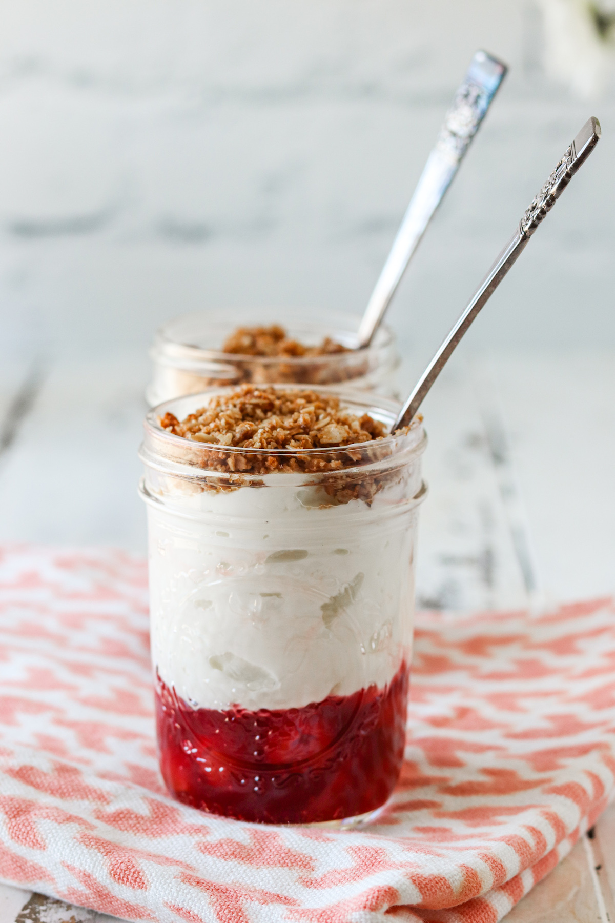 close up of two jars of prepared cherry pie yogurt parfait