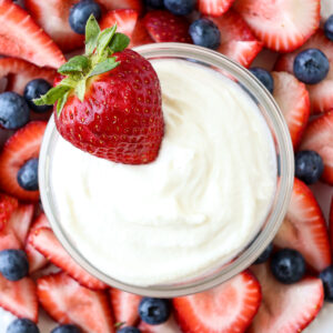 creamy cheesecake fruit dip with a strawberry
