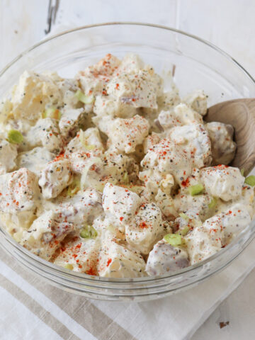 bowl of prepared red skin potato salad with eggs and sour cream mayonnaise dressing