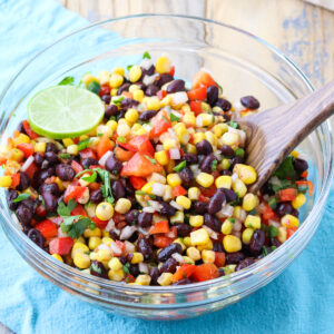 bowl of canned black bean and corn salsa with lime garnish