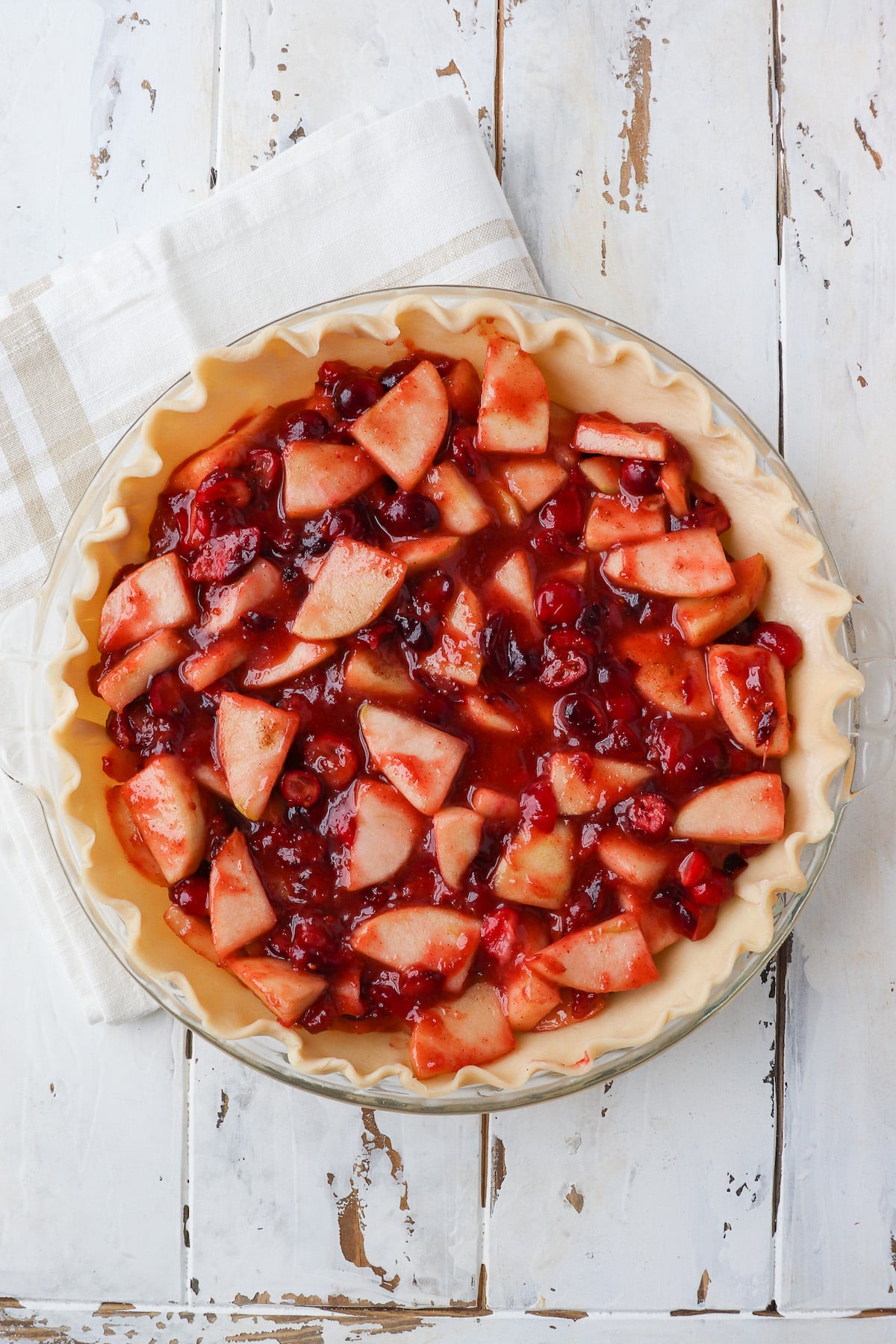 cooked cranberry apple pie filling in pie crust