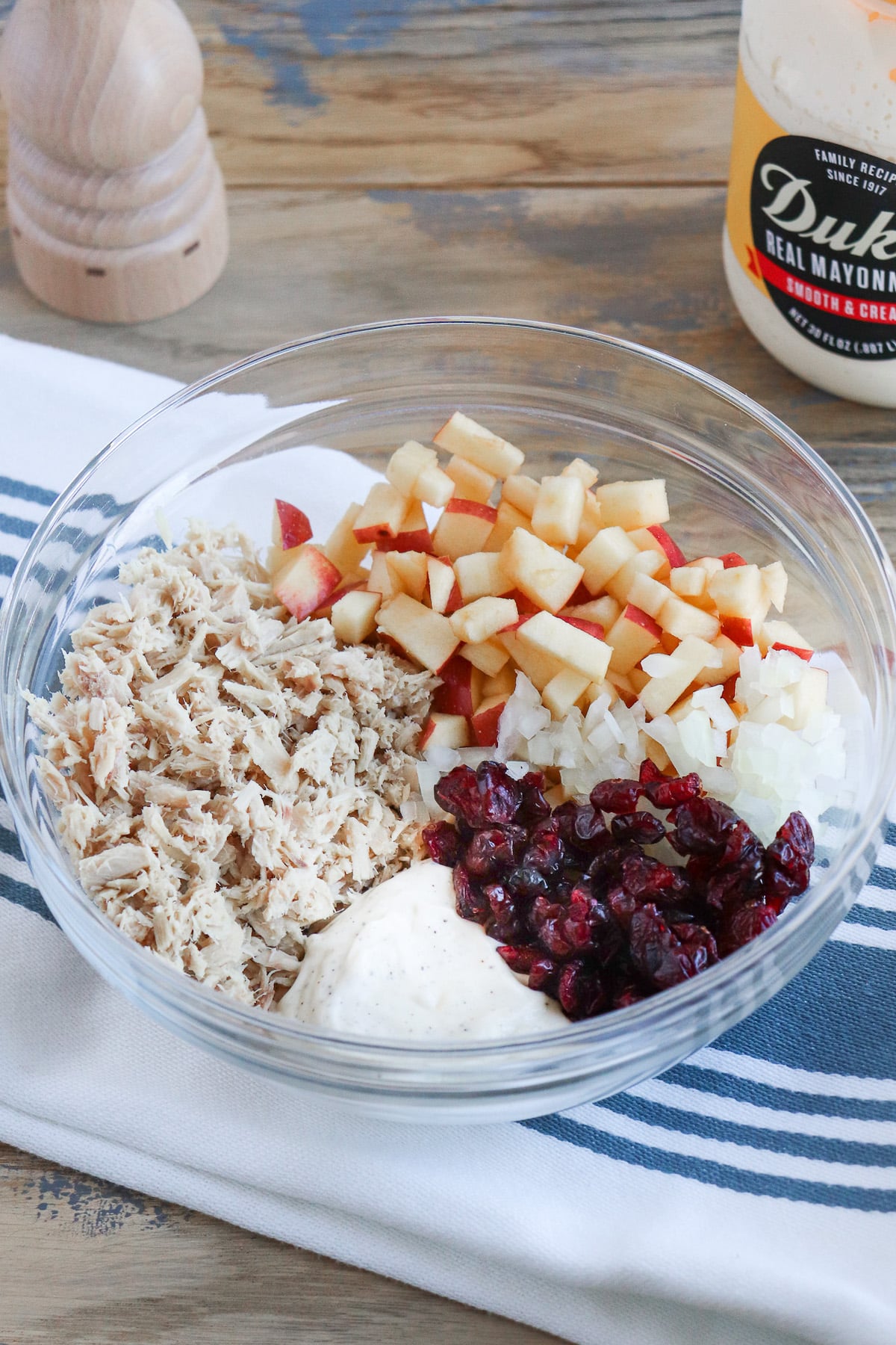 tuna, apples, dried cranberries, mayo in a bowl