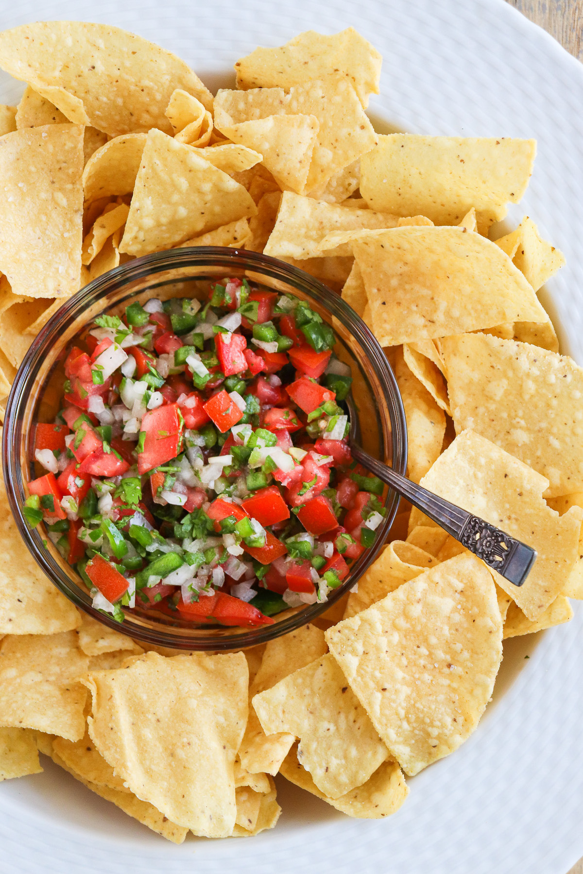 bowl of prepared pico de Gallo in the center of fresh tortilla chips