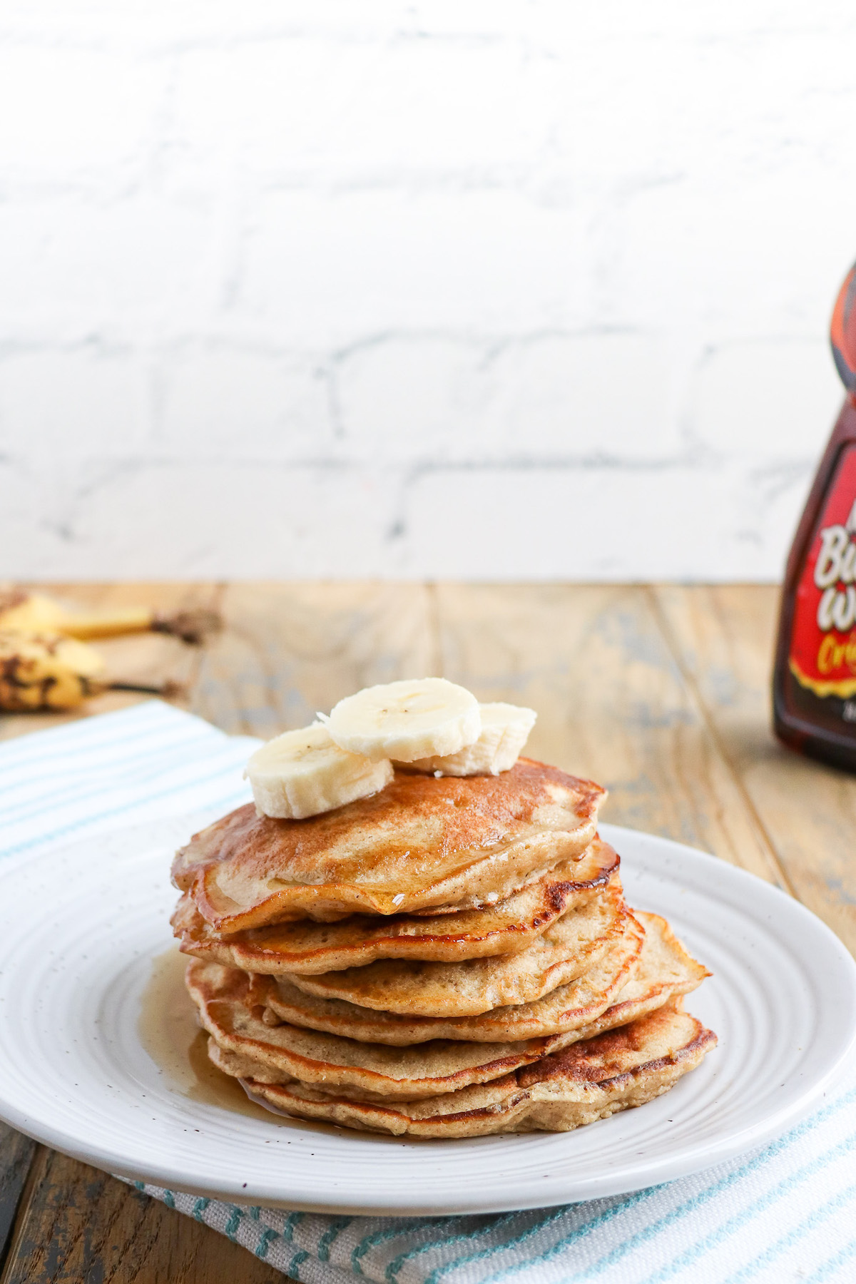 a stack of pancakes with banana slices