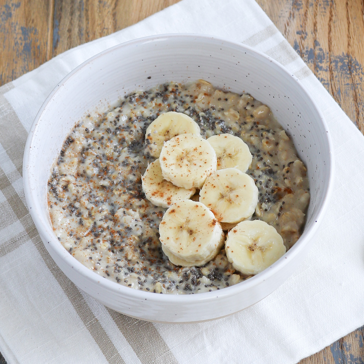 close up of prepared oatmeal with banana and lots of chia seeds