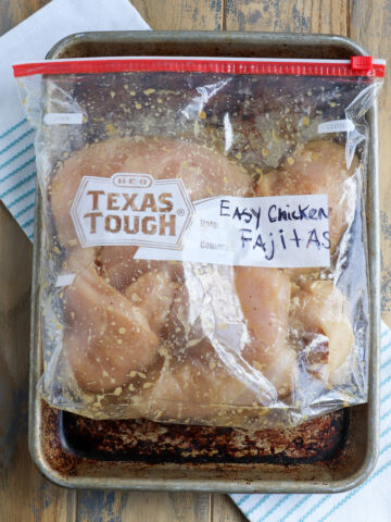 gallon bag with butterflied chicken breasts coated in easy chicken fajita marinade
