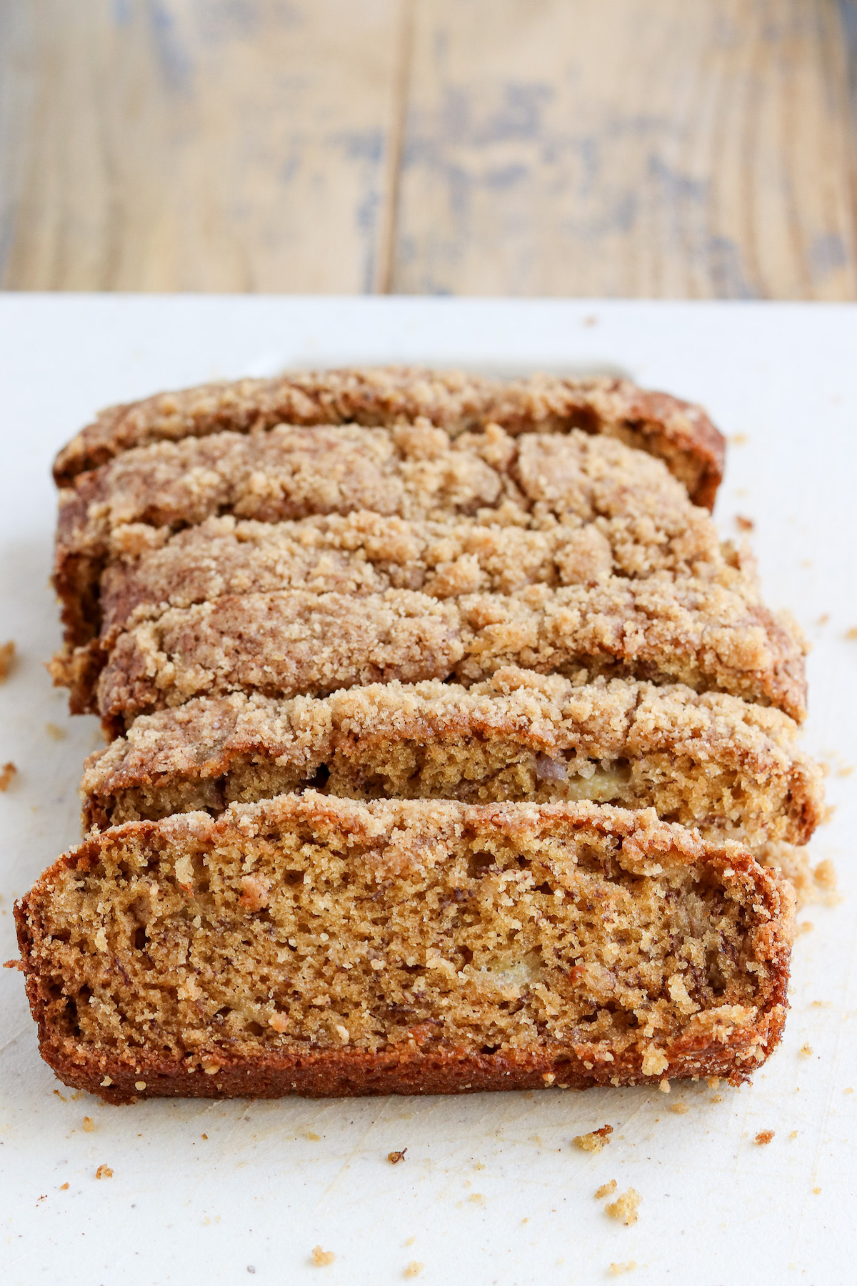 sliced loaf of baked banana bread with crumb topping