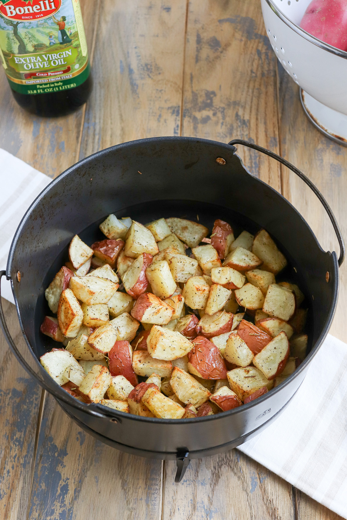 golden brown cooked potatoes in air fryer basket