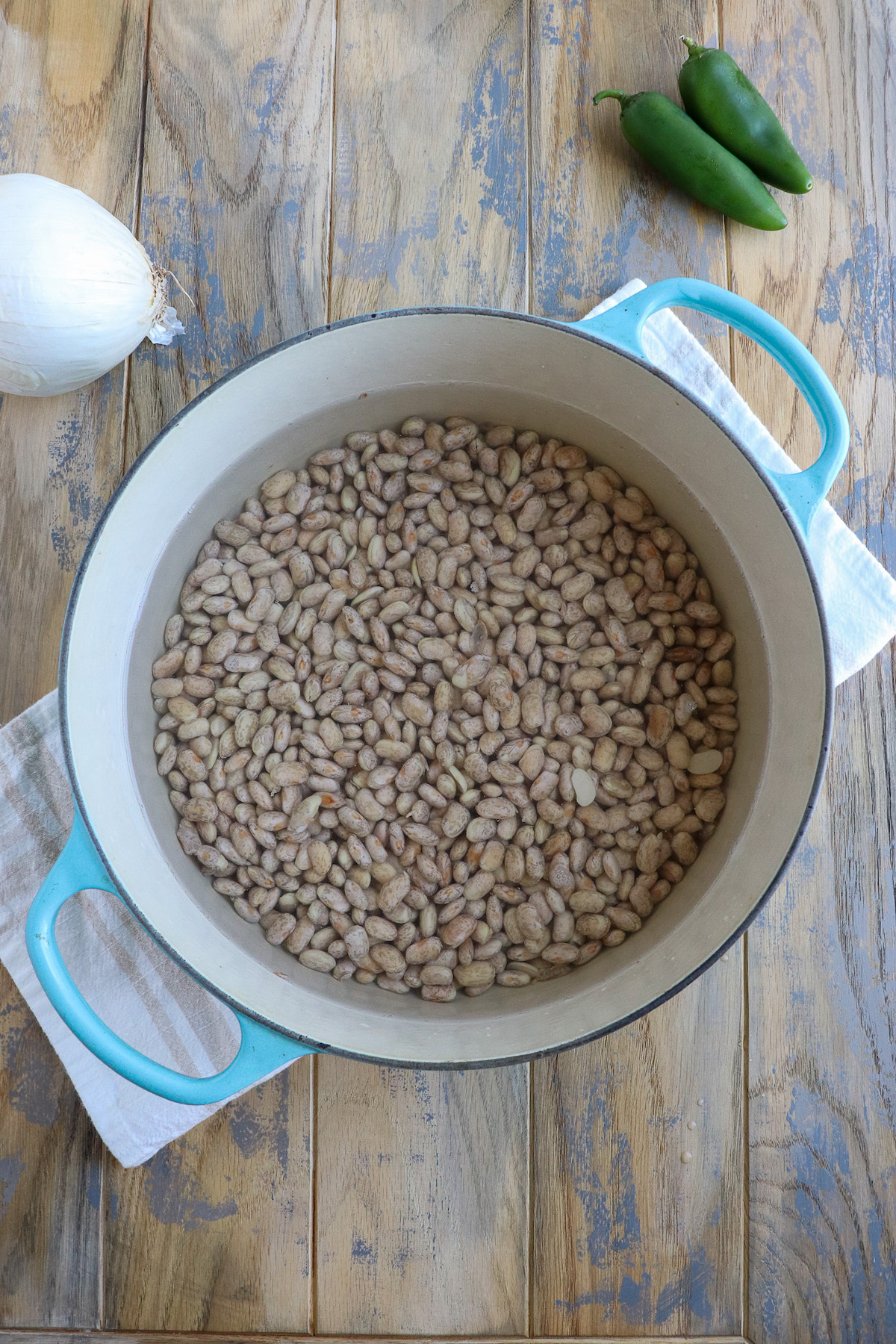 dried pinto beans in dutch oven covered with two inches of water for cooking
