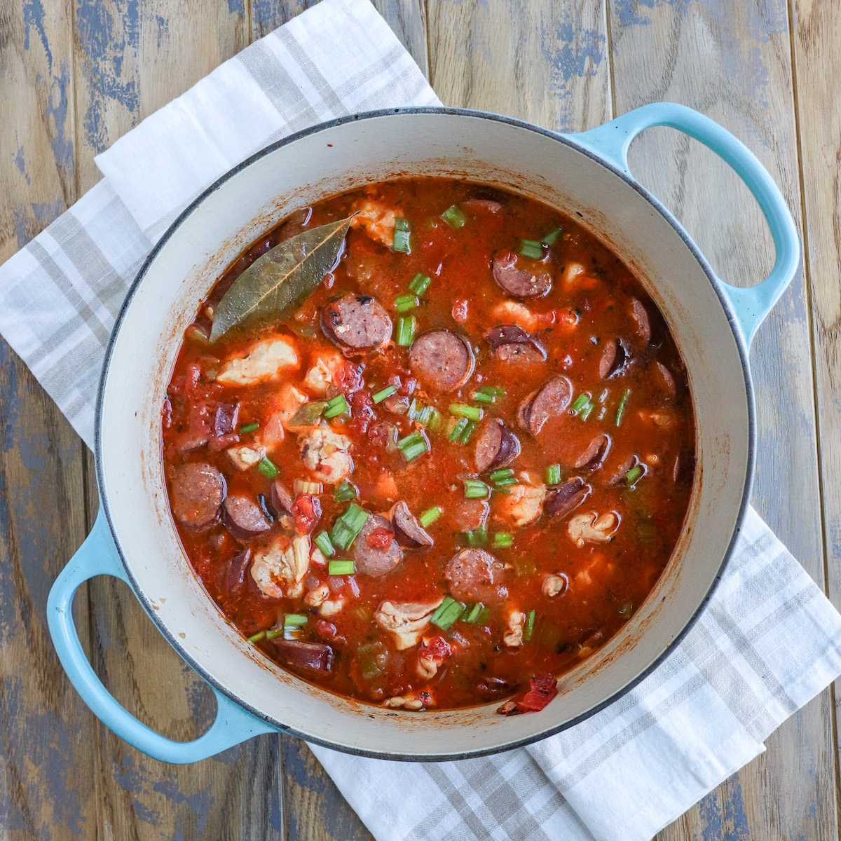 dutch oven of prepared jambalaya with chunks of chicken and sausage visible