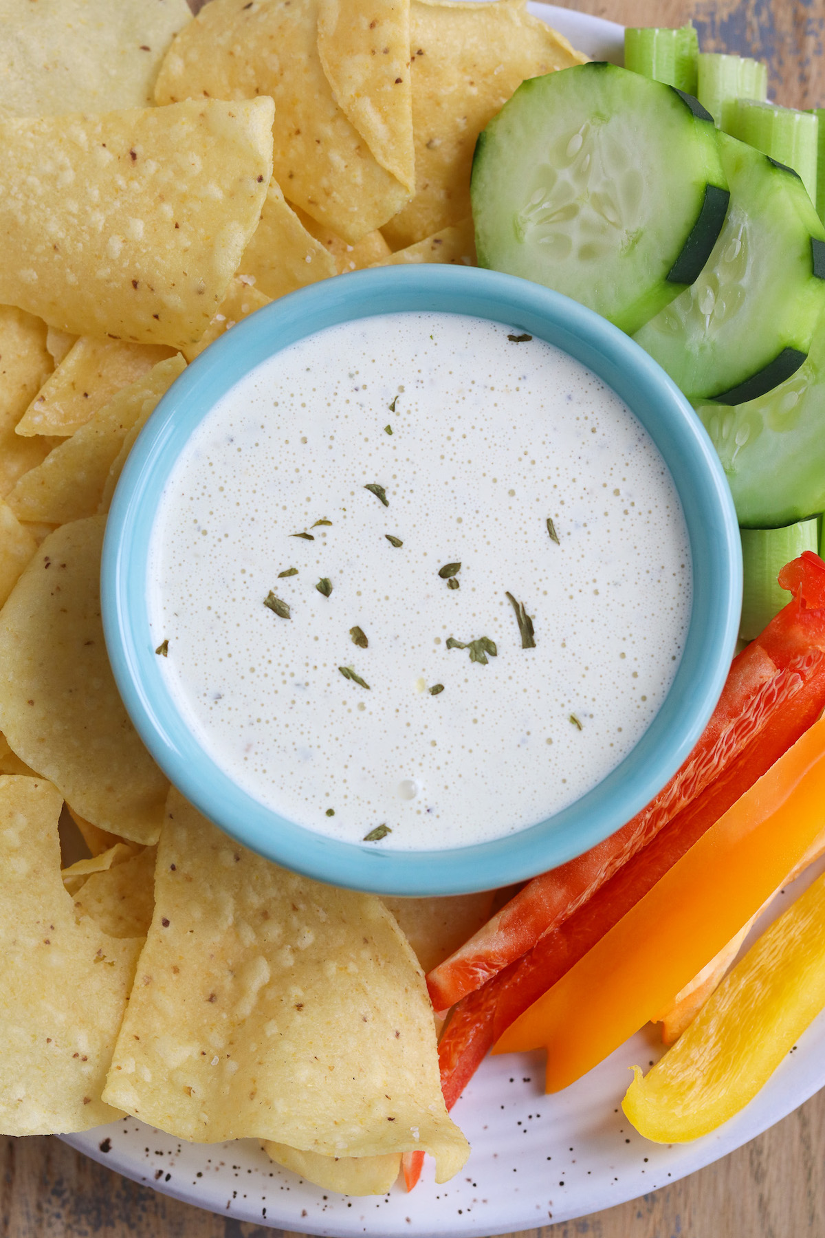 bowl of prepared dip with chips and veggies
