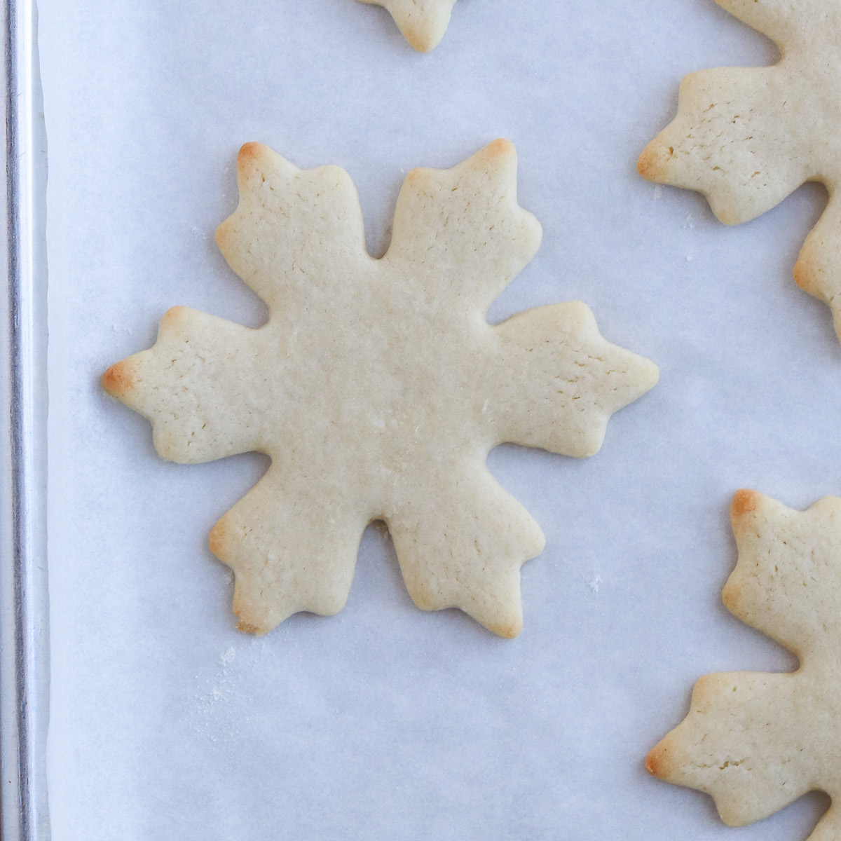 closeup of baked sugar cookie in snowflake shape