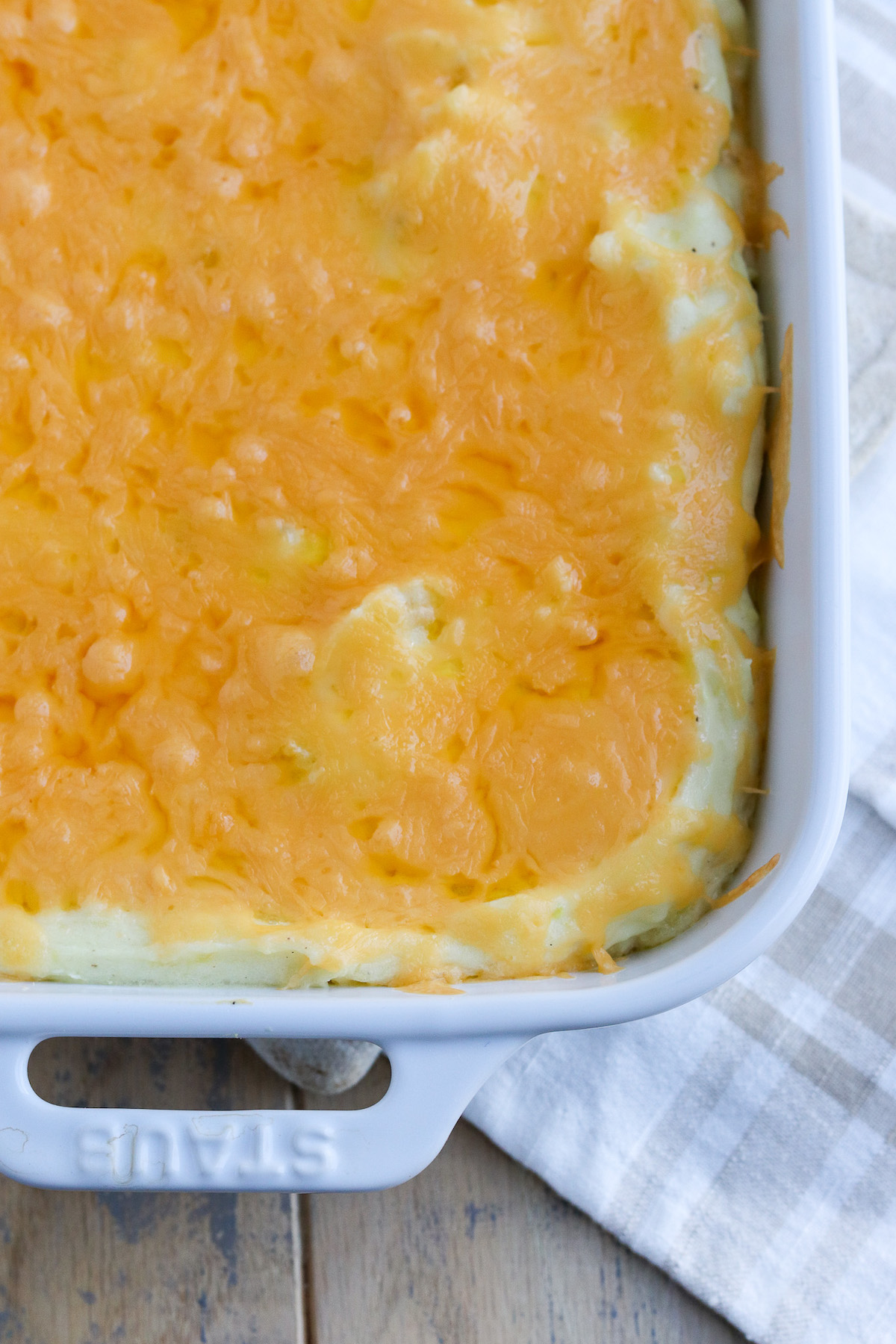 lots of cheese on top of mashed potato casserole