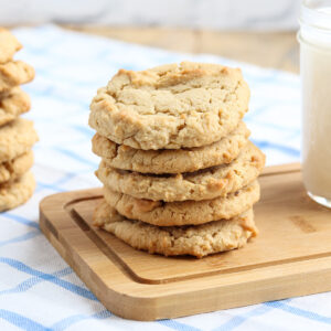 stack of 5 crunchy peanut butter cookies beside a glass of milk