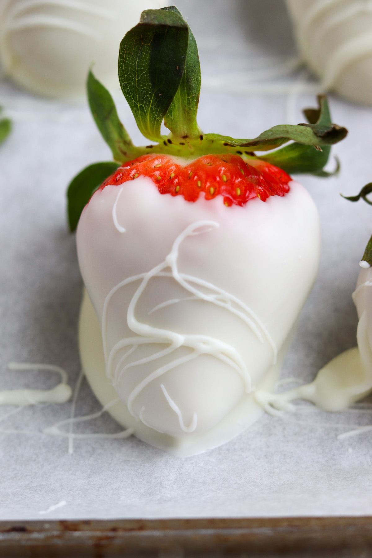 large dipped strawberry with white chocolate drizzle