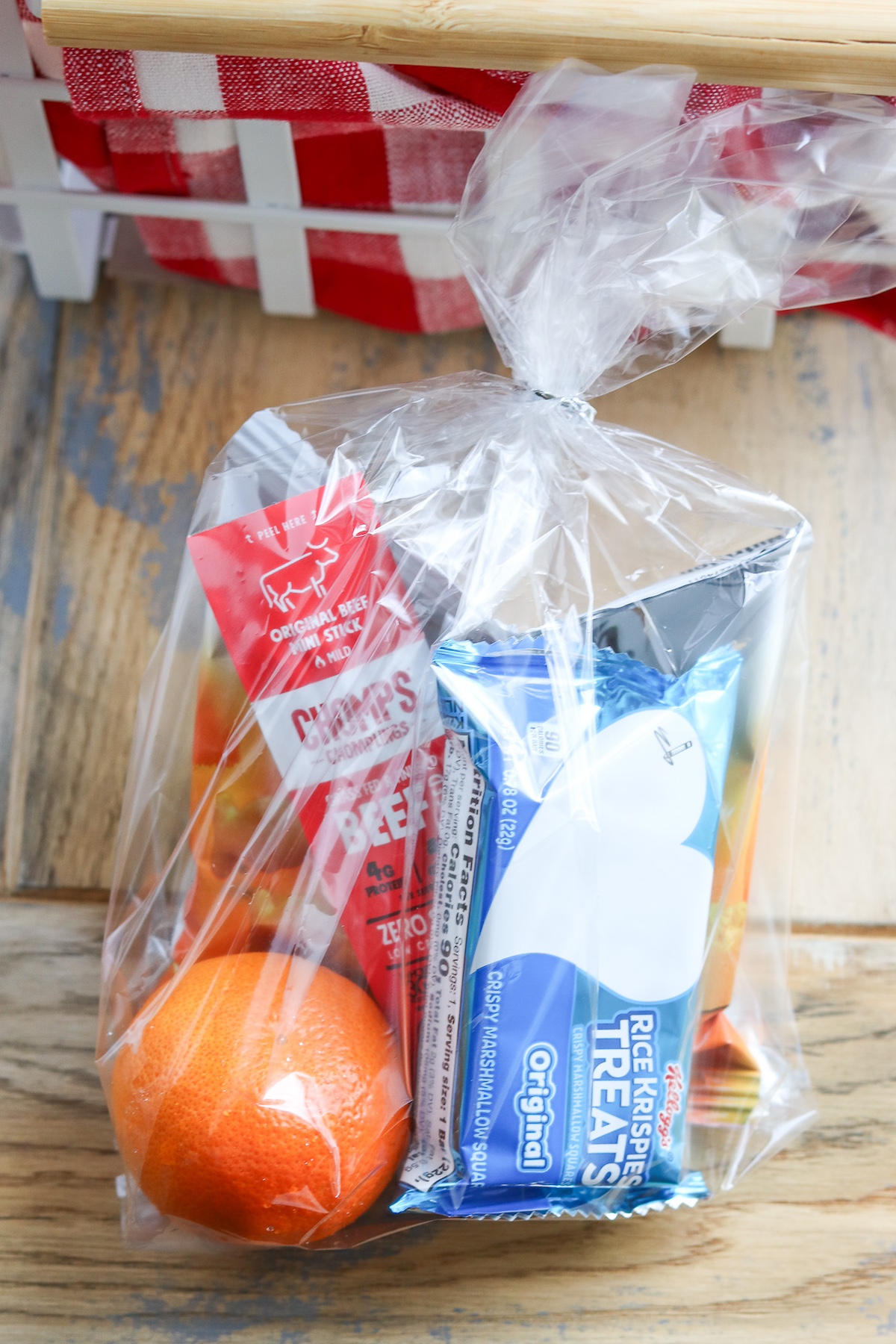 individual team snack bag with orange, rice Krispy and meat stick