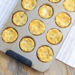 muffin tin of egg bites with visible diced green Chile and cheese