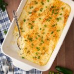 baked cheesy jalapeno grits casserole with serving spoon