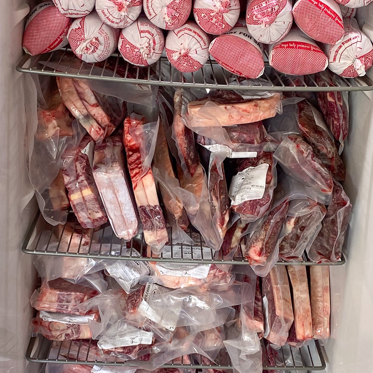 steak, roasts and ground beef packed tightly in a deep freeze stand up freezer