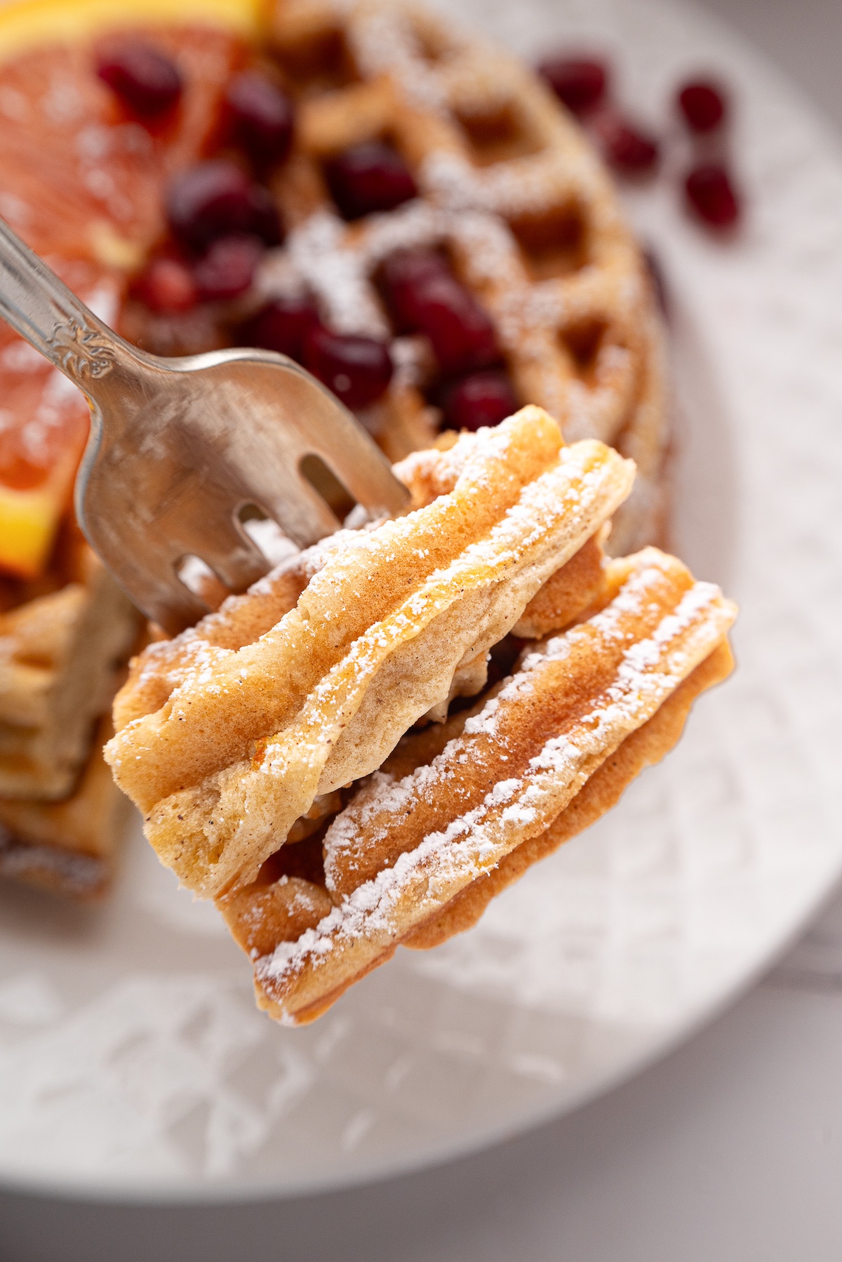 a fork with a bite of waffle