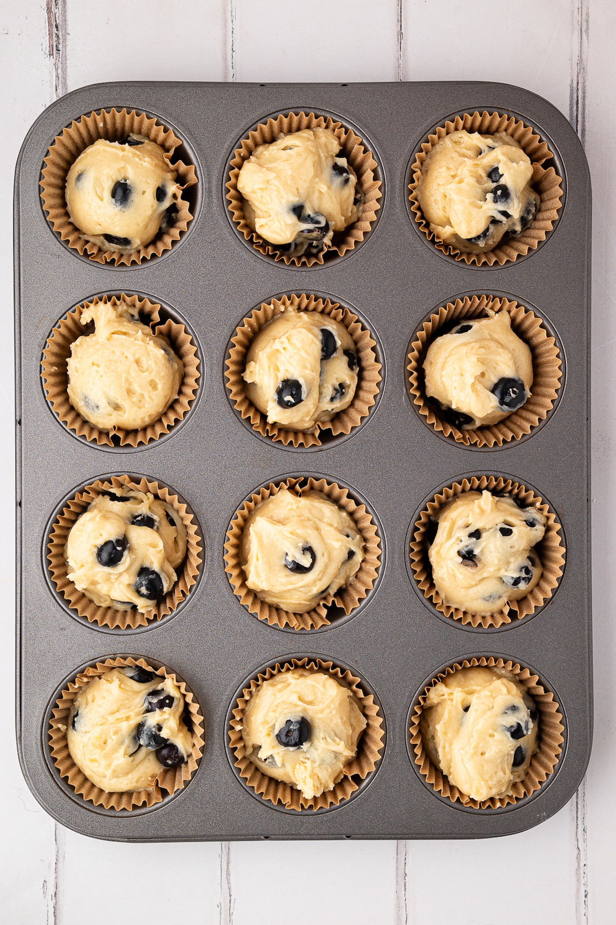 muffin batter in muffin lined tin