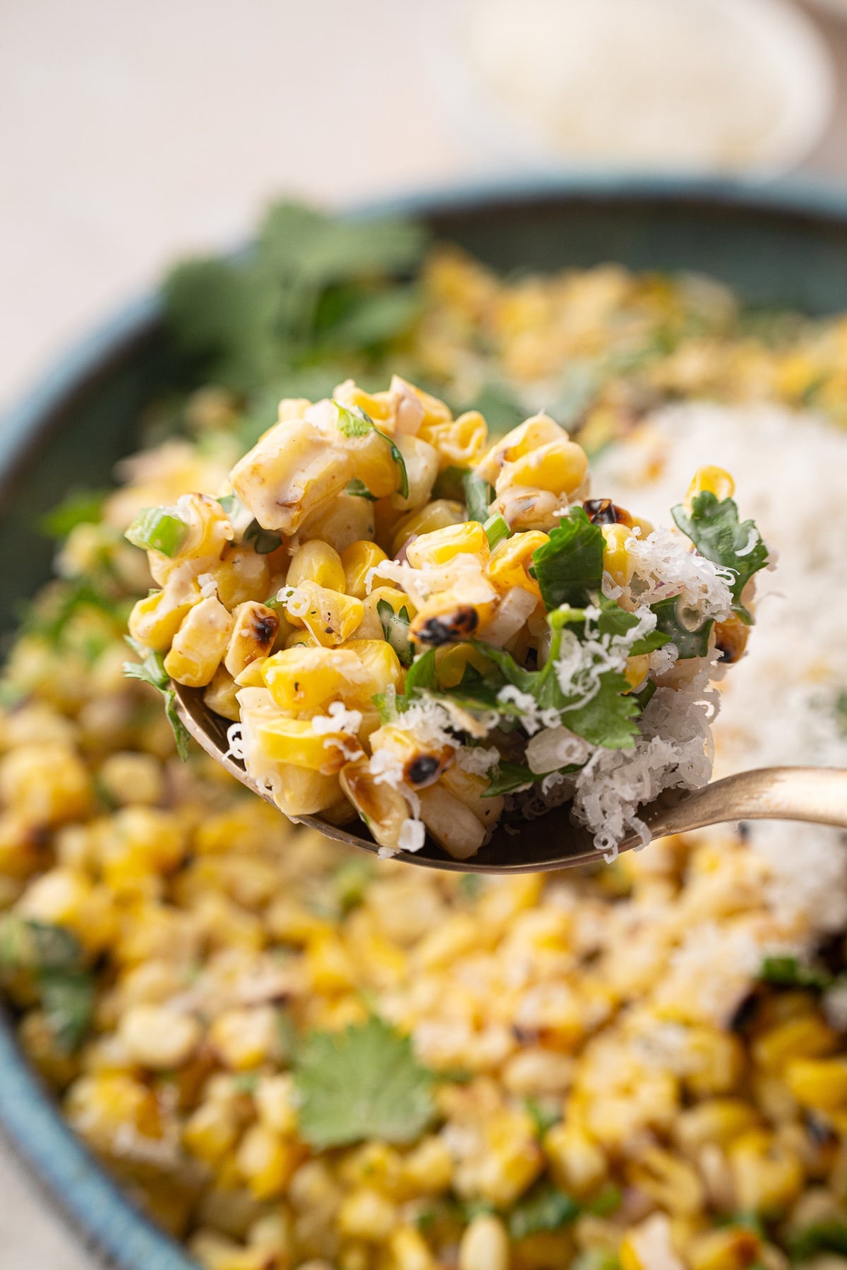 bite of street corn with creamy cheese