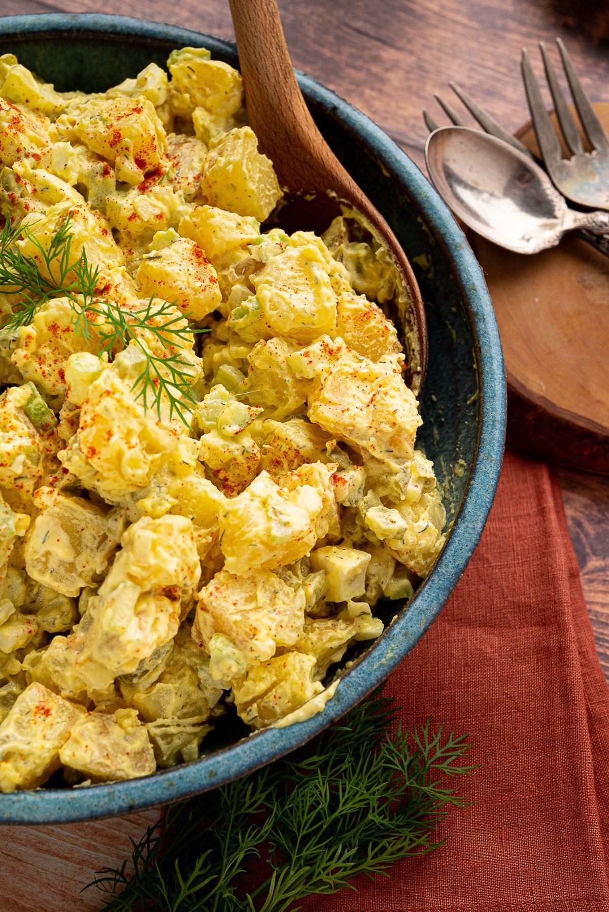 turquoise serving bowl full of texas mustard potato salad