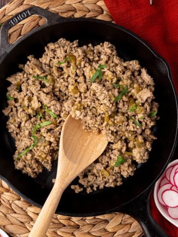 skillet of cooked turkey taco meat with cilantro garnish