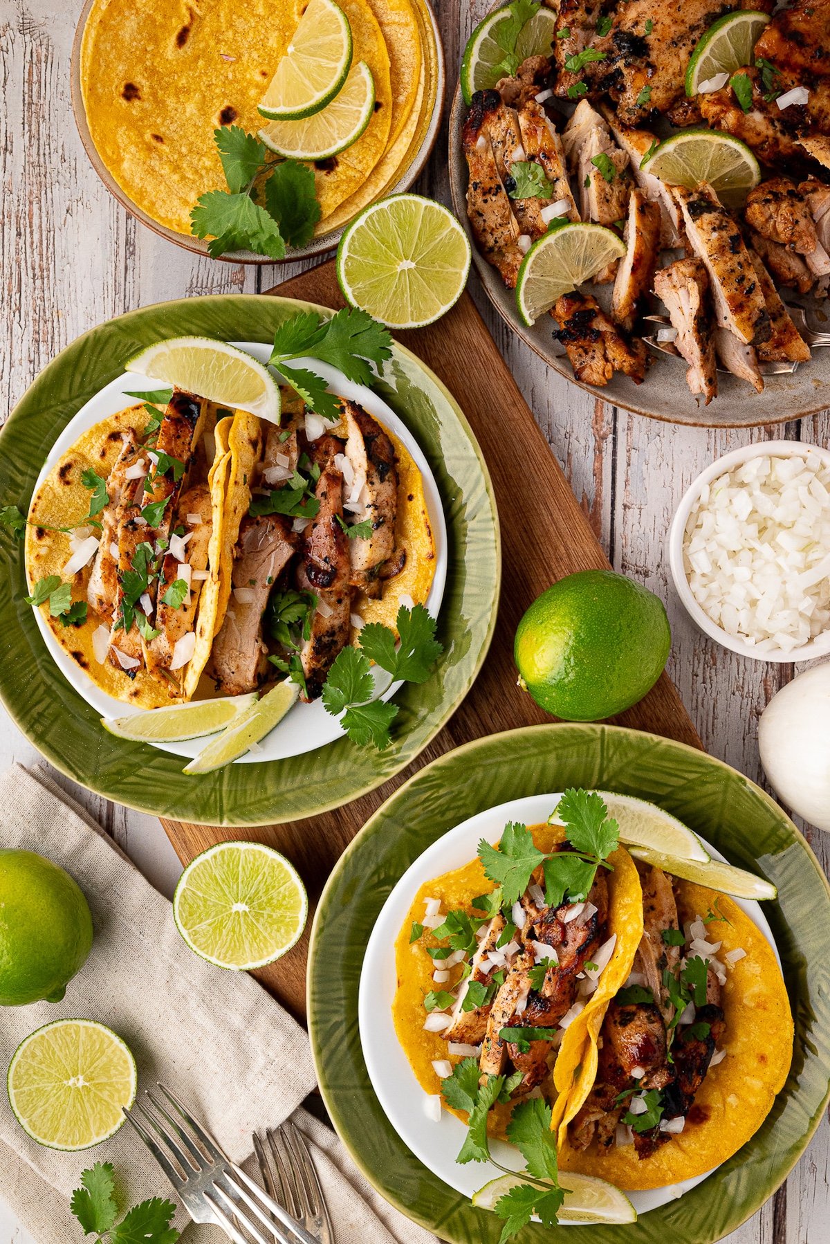 corn tortillas with chicken thighs, cilantro, onion and lime