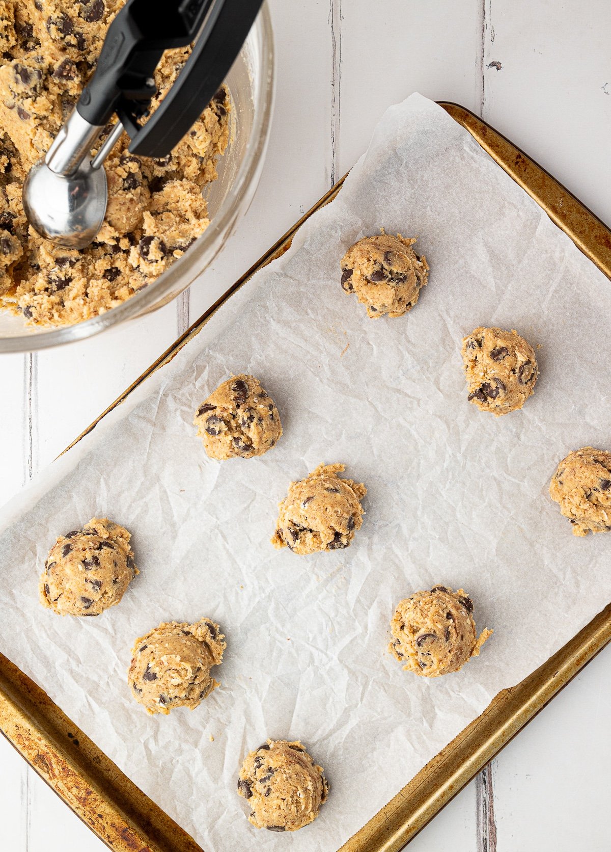 cookies scooped onto parchment lined baking sheet