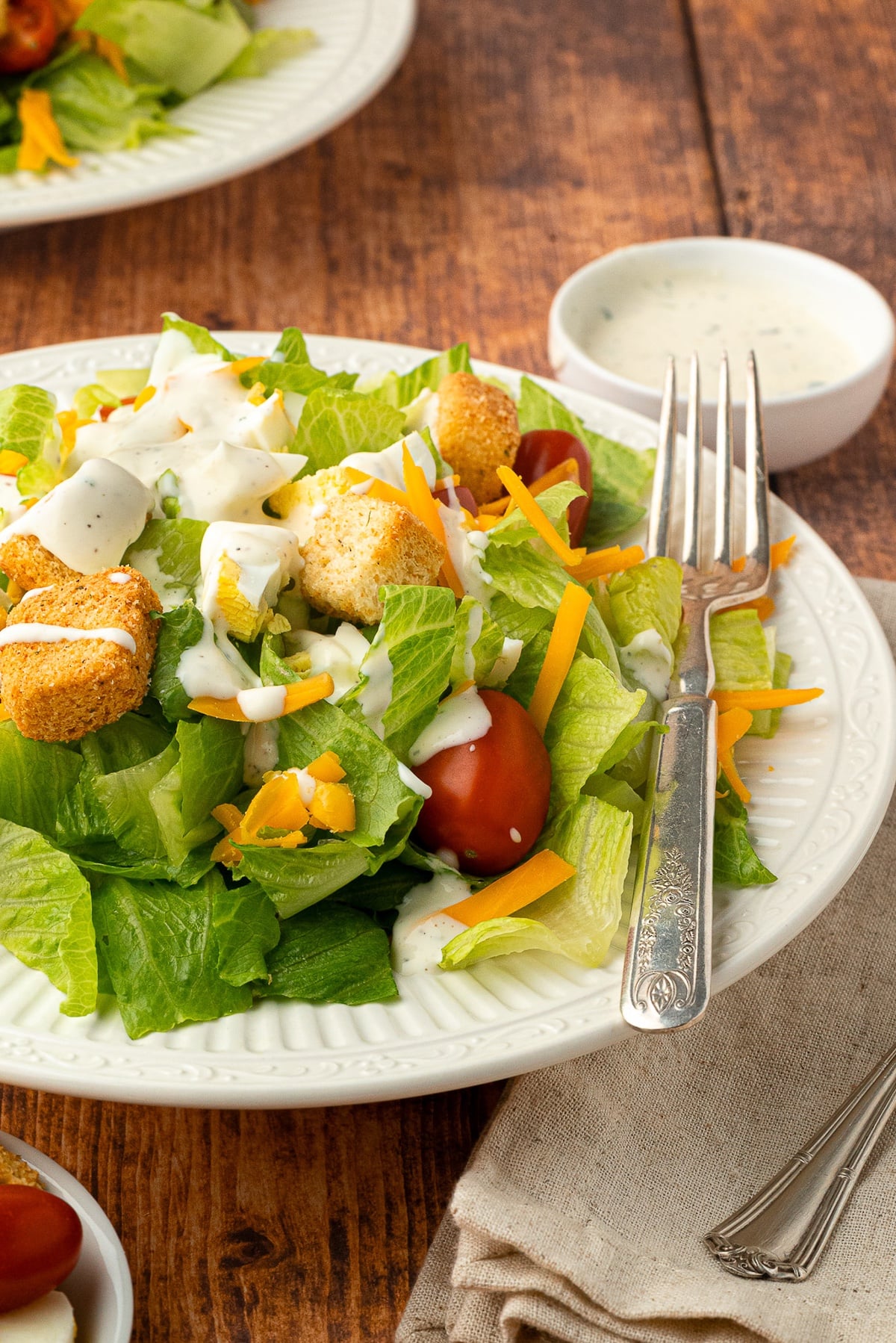 plated salad topped with ranch dressing