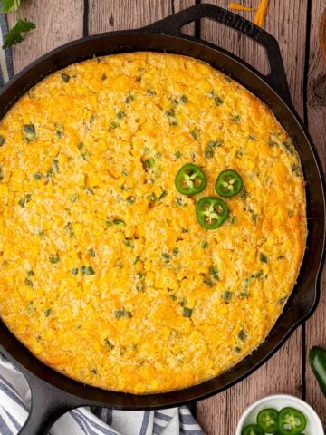 classic Jalapeno Corn Casserole with a creamy consistency and jalapenos for a bit of spice in a cast iron skillet