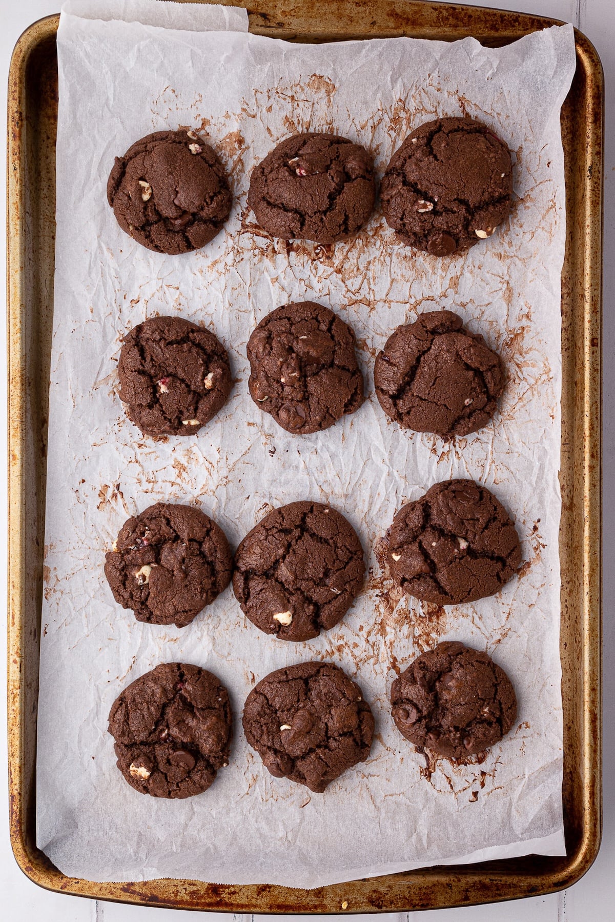 Cookies on the parchment lined baking sheet after being removed from the oven.