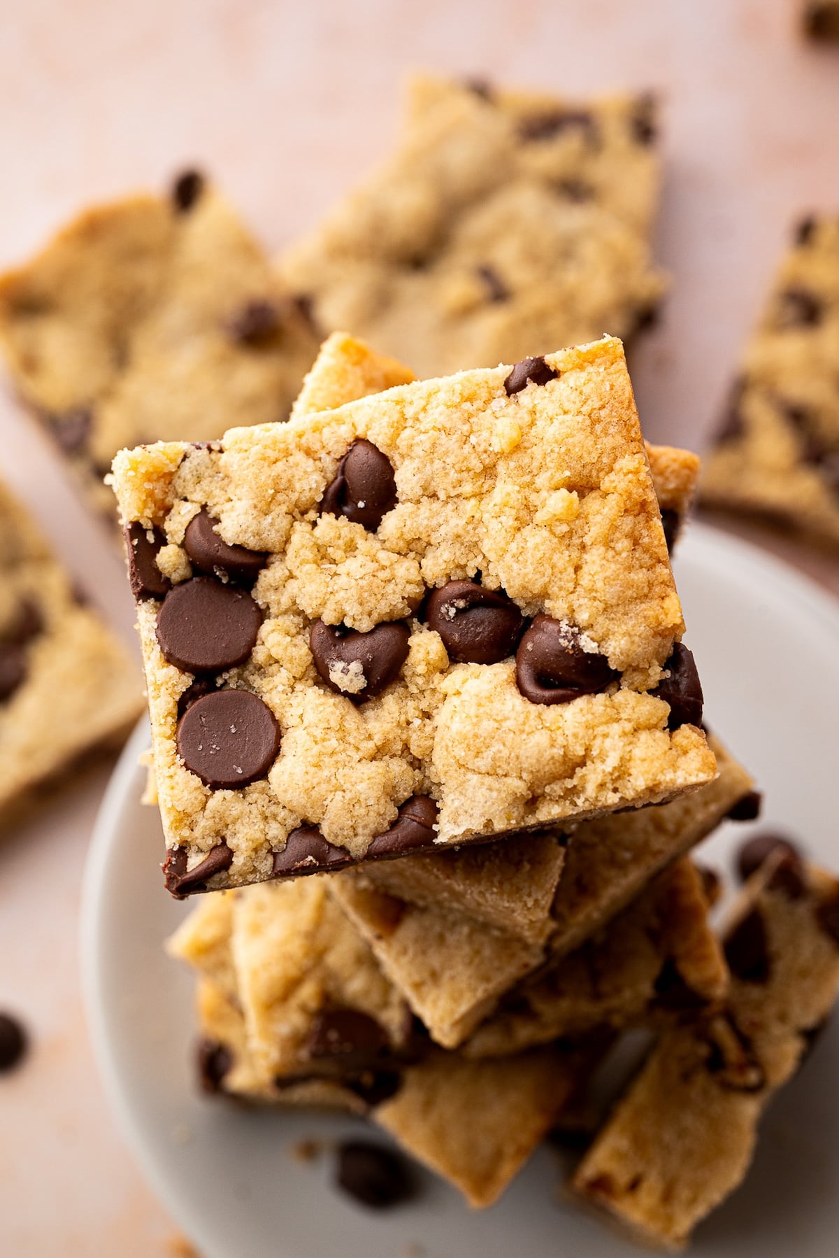 A stack of baked chocolate chip cookie bars with the perfect golden brown color.