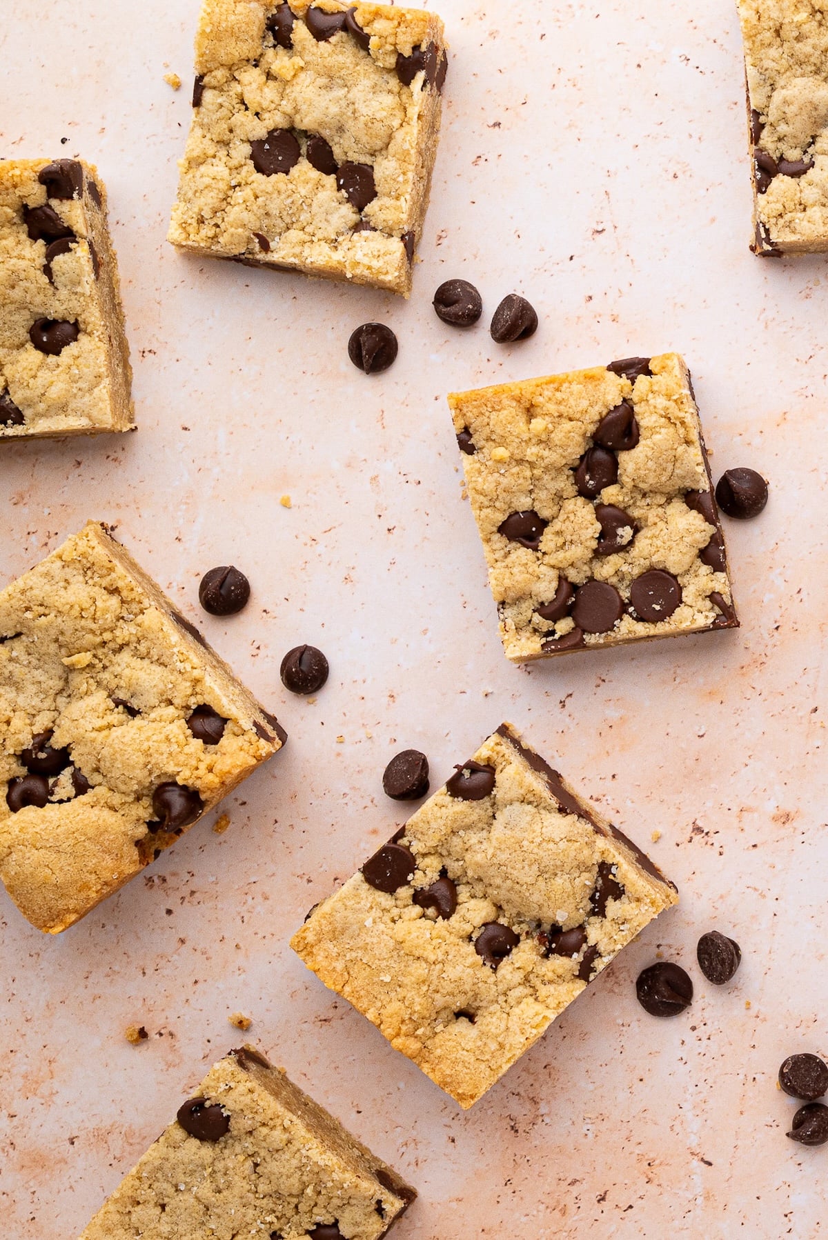 Cut cookie bars and extra chocolate chips sprinkled around them.
