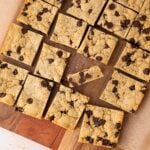 Bourbon Chocolate Chip Cookie Bars cut into squares with a blondie center and chewy cookie like edges and a golden brown top.