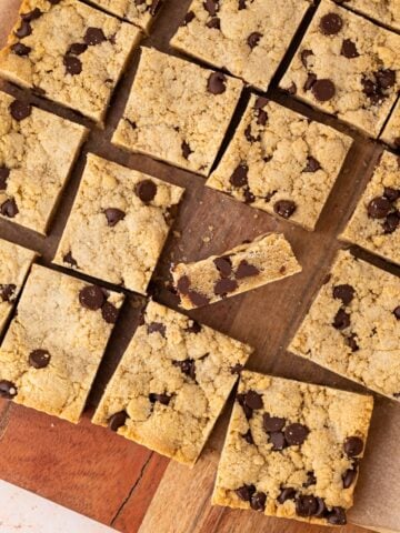 Bourbon Chocolate Chip Cookie Bars cut into squares with a blondie center and chewy cookie like edges and a golden brown top.