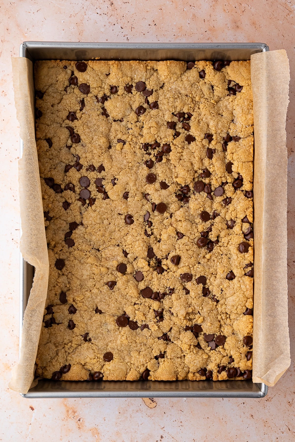 Bourbon Chocolate Chip Cookies Bars just out of the oven with golden brown edges and lots of melty chocolate chips.