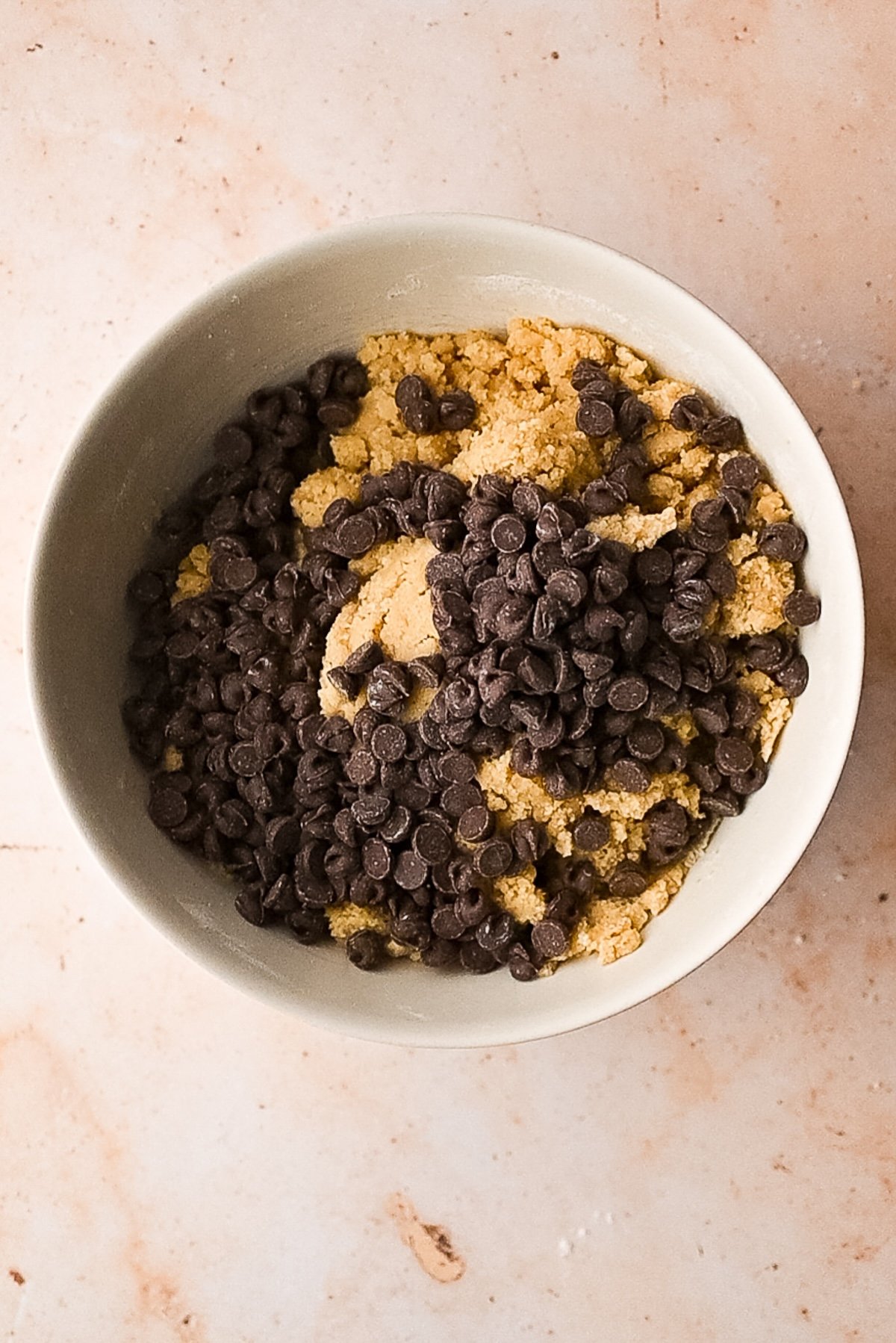 Folding in lots of chocolate chips to the batter.