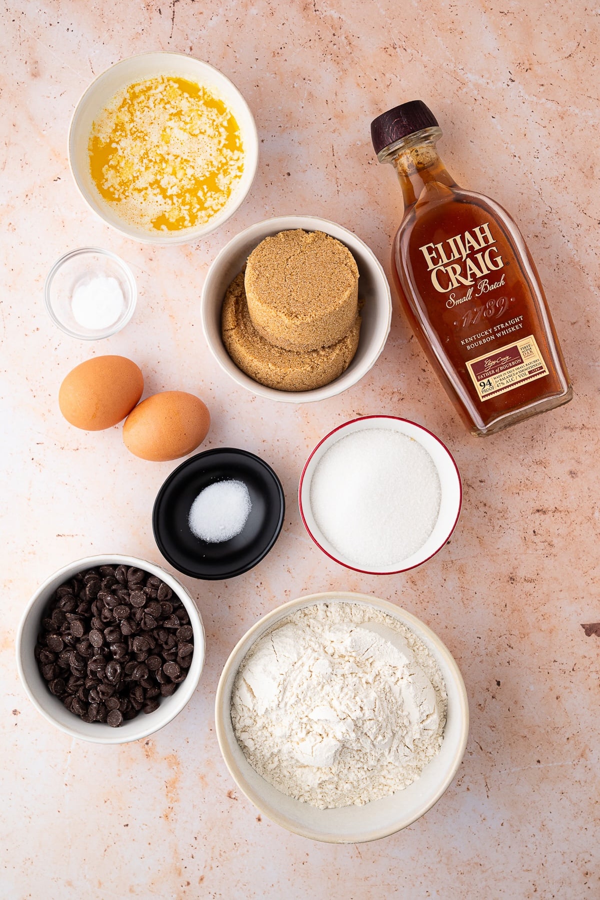 Ingredients for bourbon blondies melted butter, bourbon, brown sugar, eggs, flour, chocolate chips and leavening agents.