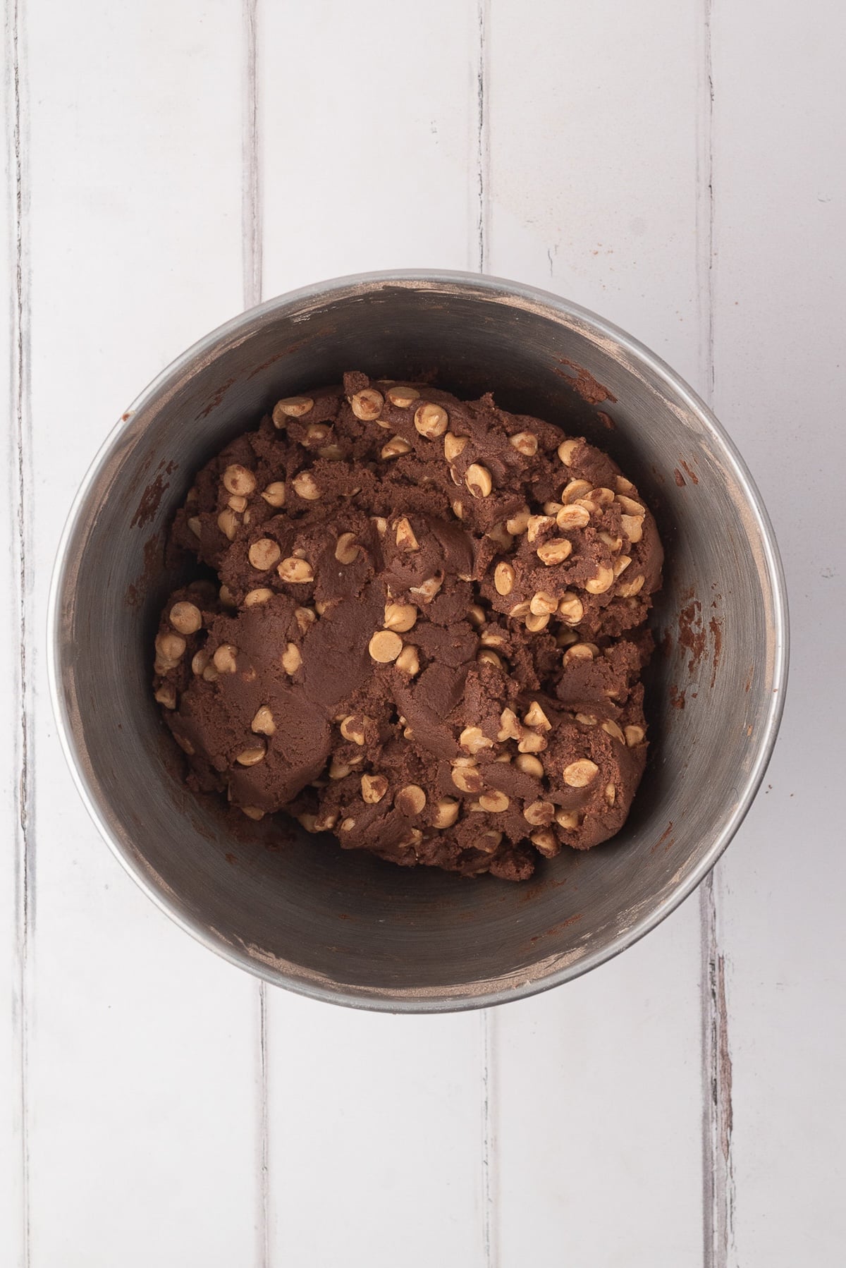 Folding in the Reese's peanut butter chips into this thick cocoa cookie dough.