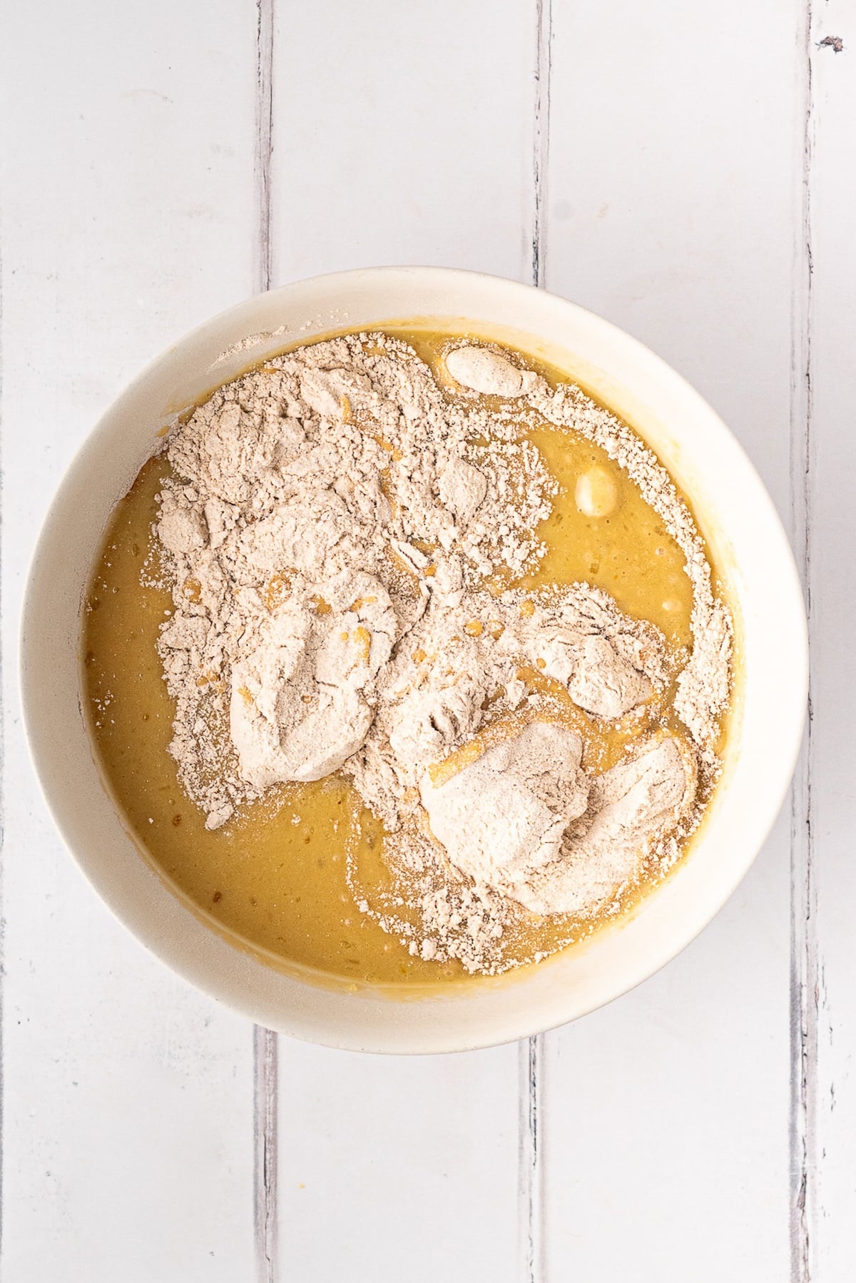 Mixing buttermilk, eggs, and oil for a moist, nut-free muffin base before stirring in dry ingredients.