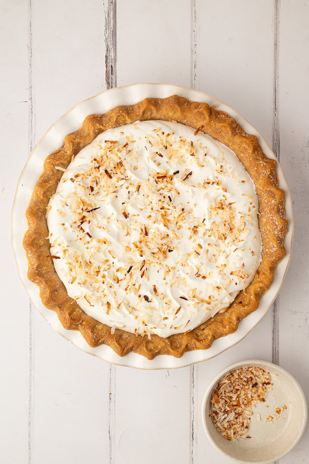 Topping the pie with toasted coconut.