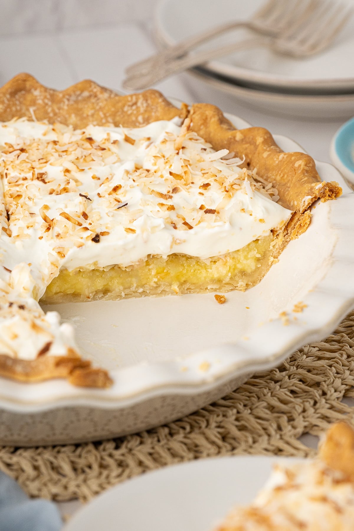 A side shot showing the coconut custard pie filling, which is a rich yellow color with visible coconut flakes.