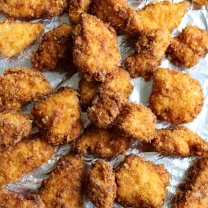 Crispy cornflake coated fried chicken nuggets fresh out of the the skillet.